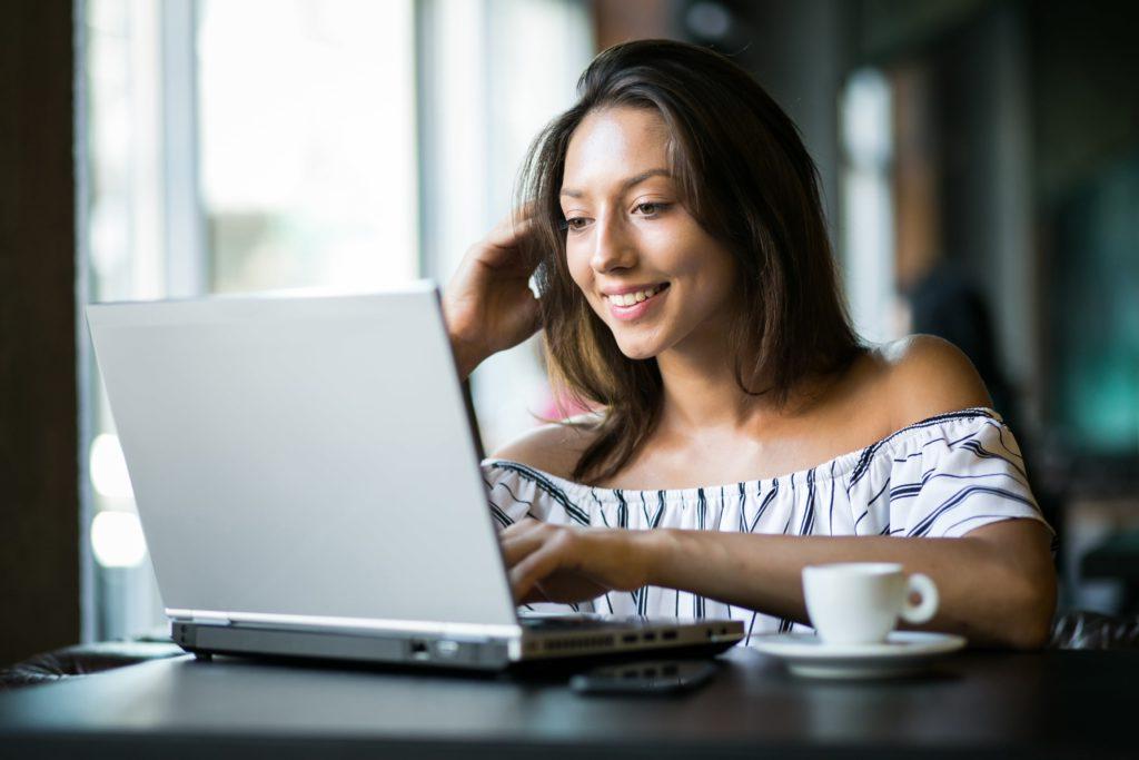 Young Woman at computer with coffee
