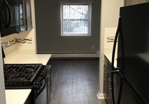 Kitchen with black appliances at Bromley House apartments for rent