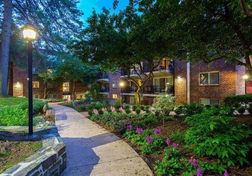 Beautifully landscaped entrance walkway to residential buildings at Haverford Court apartments
