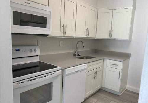 a kitchen with white cabinets and white appliances - Elkins Park terrace