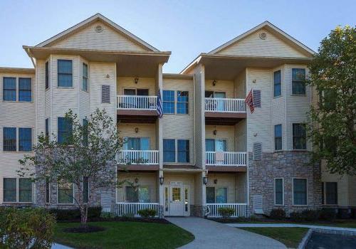 Exterior view of residential buildings at The Enclaves at Packer Park apartments for rent