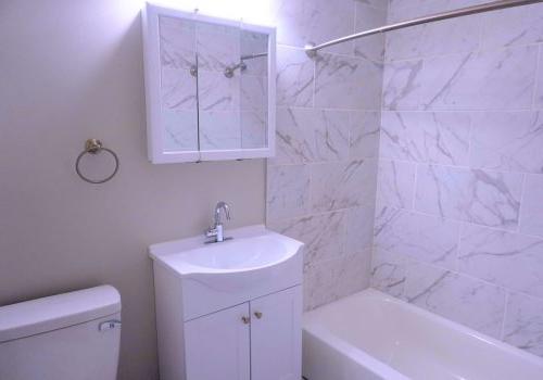 White modern bathroom with marbled shower