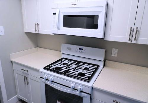 White modern kitchen with modern appliances and quartz countertop