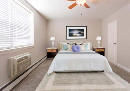 Fully furnished bedroom with a ceiling fan and open window at Willow Bend apartments for rent